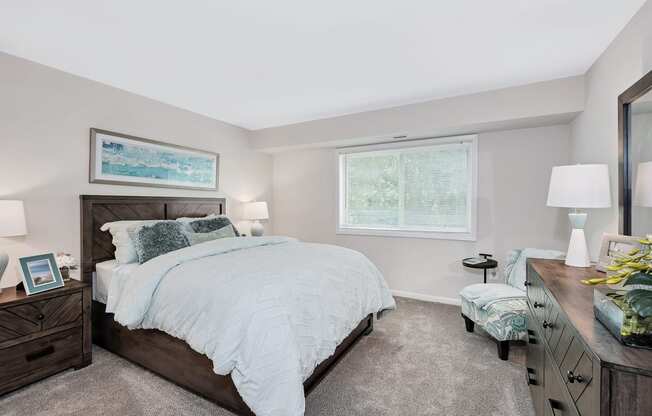 a bedroom with a bed and dresser