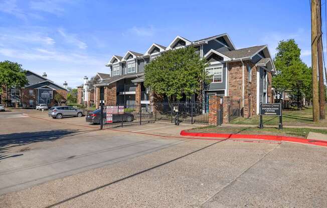A street view of a residential area with a signboard in the foreground.