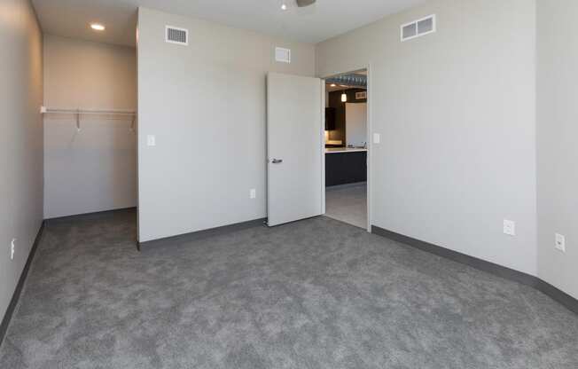 Spacious living room with neutral walls and ample natural light.