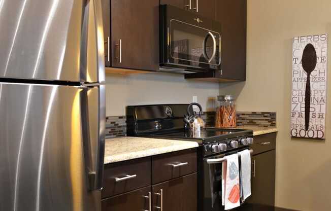 a kitchen with stainless steel appliances and wooden cabinets