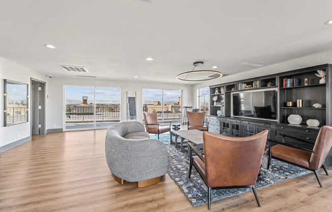 A modern living room with a grey chair and brown leather chairs.