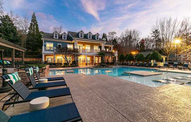 A large house with a pool in front of it.