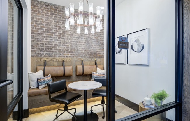 a living room with a couch and a table and a chandelier