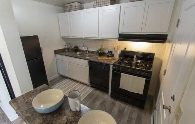 This is a photo of the kitchen in the 740 square foot 1 bedroom model apartment at Compton Lake Apartments in Mt. Healthy, OH.