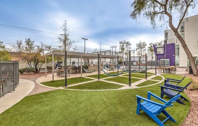 A park with a blue bench and a green lawn.