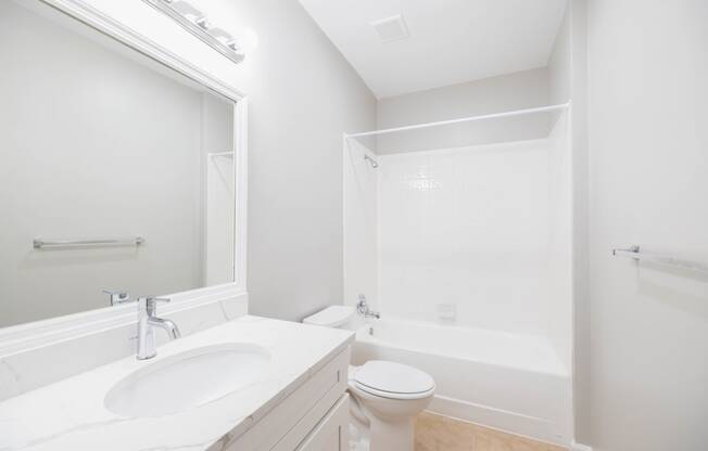 a bathroom with a sink toilet and a bath tub