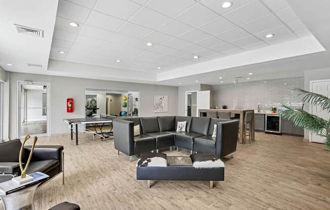 A modern living room with a grey sofa set and a wooden floor.