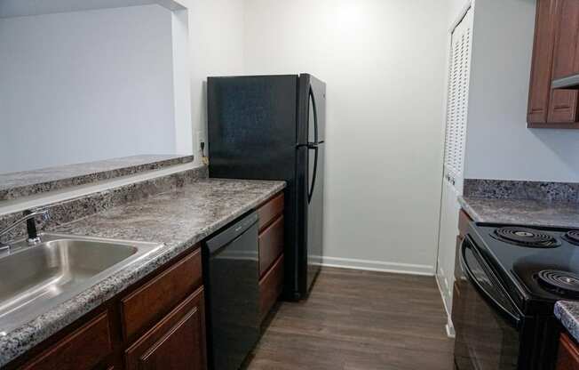Fully Equipped Kitchen with granite counter tops at Woodcrest Apartments in Westland, Michigan