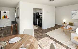 A modern dining room with a wooden table set for two.