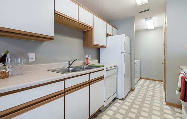 kitchen with laundry room off to side at Williamsburg Park Apartments in Lincoln NE