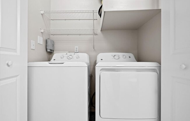 a washer and dryer in a laundry room with white appliances