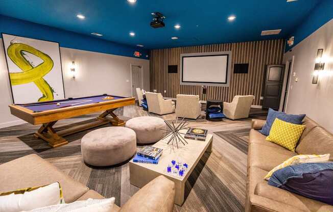 A room with a pool table and a couch.