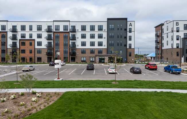 an empty parking lot in front of an apartment building at The Edison at Maple Grove, Maple Grove