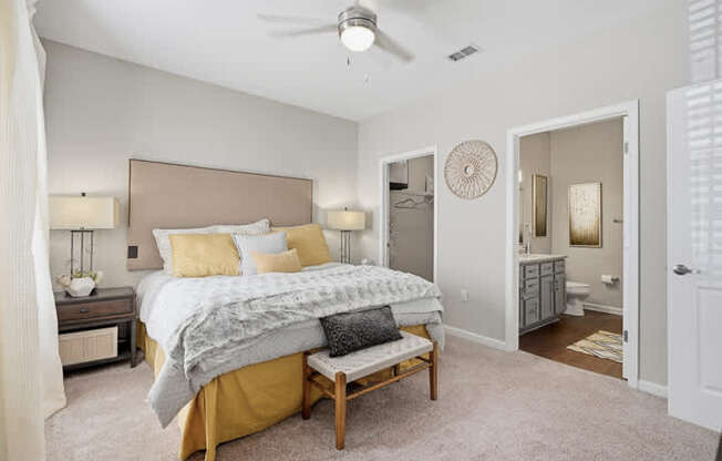 A bedroom with a bed, nightstands, and a ceiling fan.