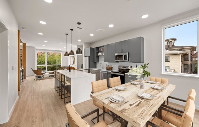 a kitchen and dining room with a table and chairs