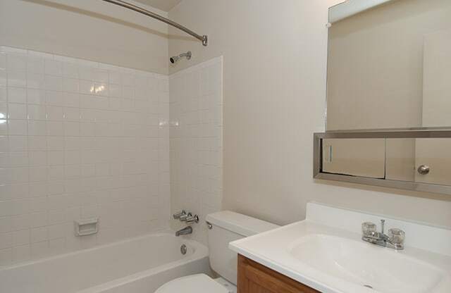 Bathroom with tub, sink and mirror