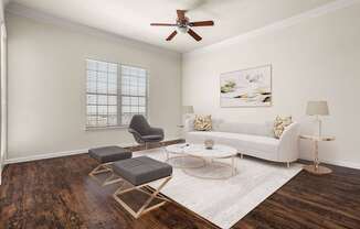 A living room with a white couch, a chair, a coffee table, and a painting on the wall.