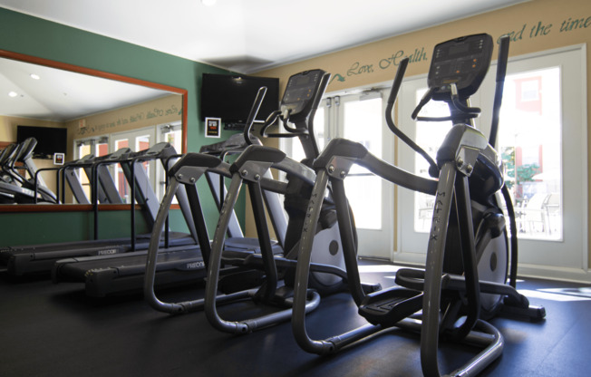 A gym with treadmills and exercise bikes.,A gym with treadmills and exercise bikes.