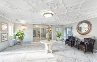 A white room with a round mirror and a table.
