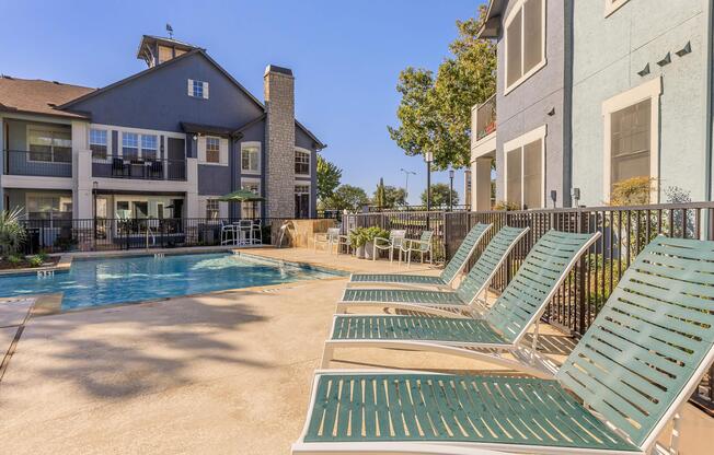a couple of lawn chairs sitting on top of a building