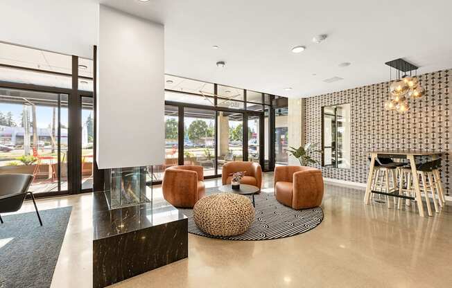 A modern waiting area with a black and white checkered wall and brown chairs.