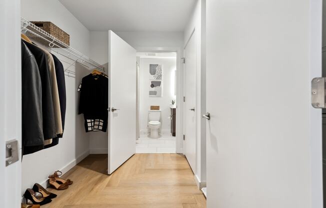 a small bathroom with white walls and a wooden floor at Hydro, Richmond