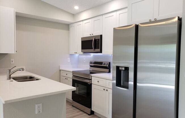 Ground Level Condo; Private Driveway; Corner Unit; Outdoor Space; Quiet Street