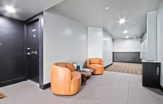 a lobby with chairs and a black door