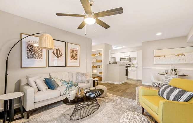 a living room with a couch and a ceiling fan