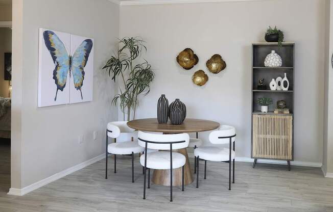 A dining room with a round table and chairs.