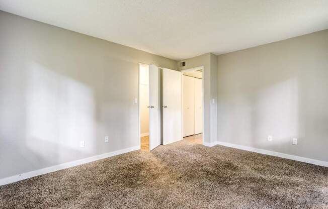 A room with a carpeted floor and white walls.