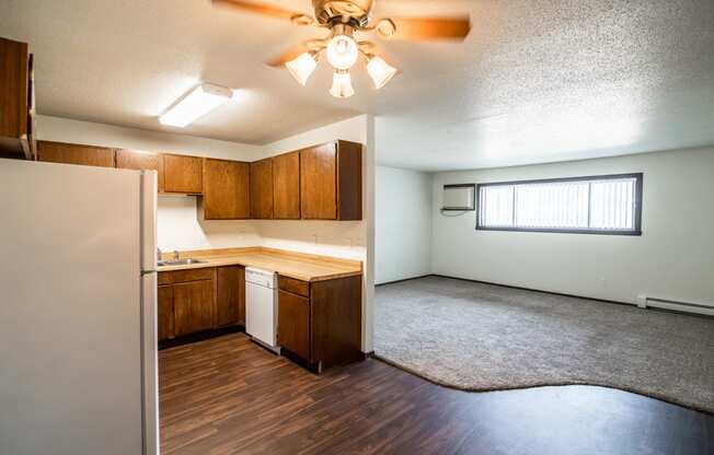 Bismarck, ND Rosser Apartments. a kitchen and living room with a ceiling fan