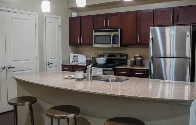 a kitchen with a granite counter top and stainless steel appliances