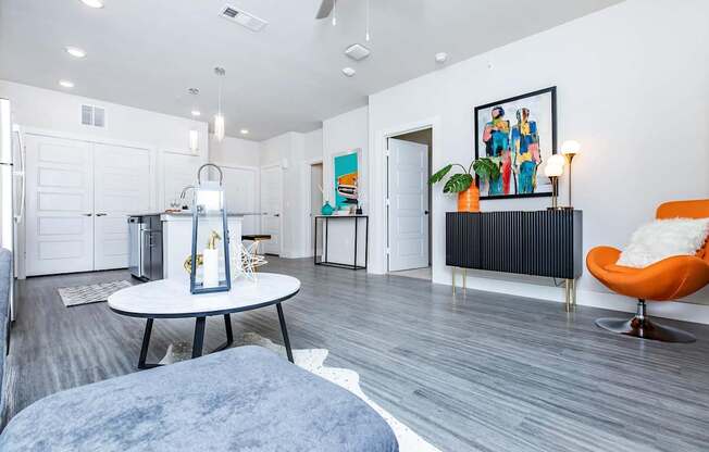 A modern living room with a grey sofa and a white coffee table.
