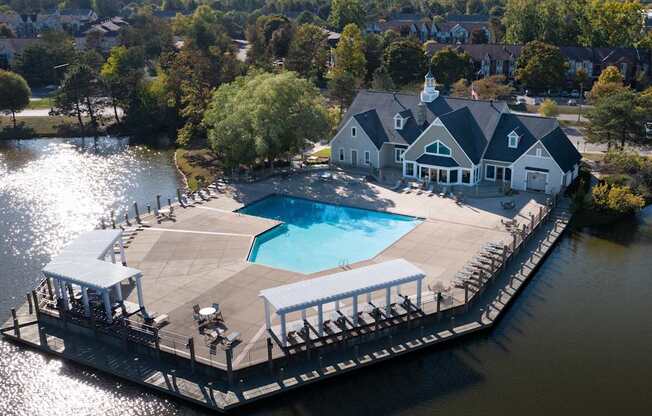 A large house with a pool is surrounded by water.