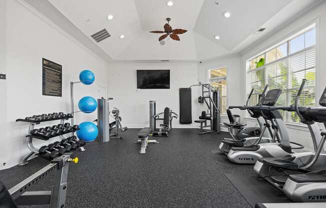 A spacious home gym with a variety of exercise equipment.
