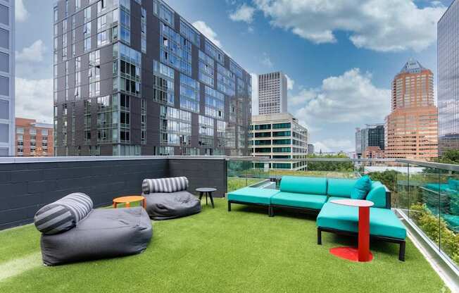 A modern outdoor seating area with bean bags and tables.