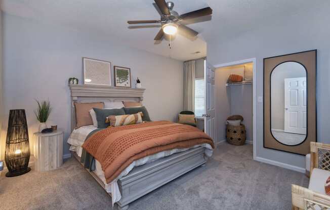 a bedroom with a bed and a ceiling fan at Whitehall Estate apartments in Charlotte NC