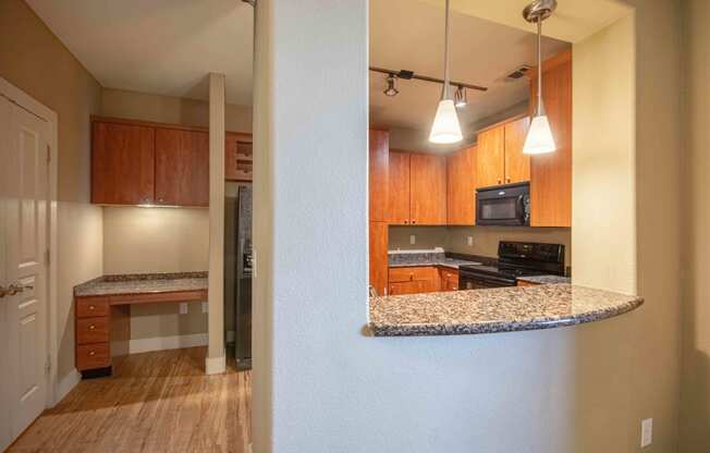 a view of the kitchen from the living room At Metropolitan Apartments in Little Rock, AR