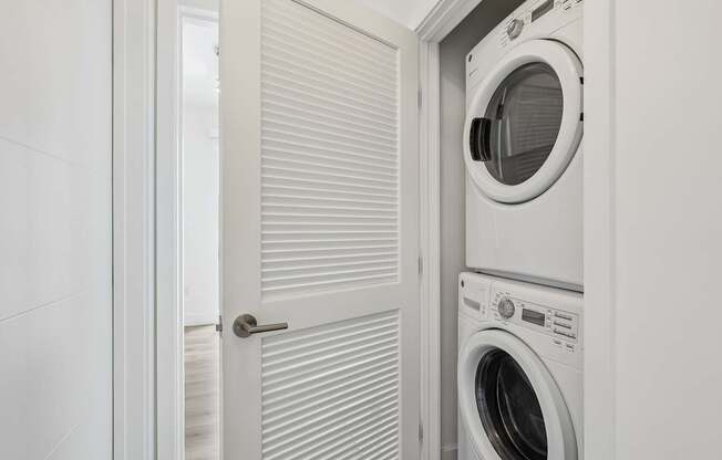 In-home front-loading washer and dryer at MB Station apartments in Miami, providing added convenience for everyday living.