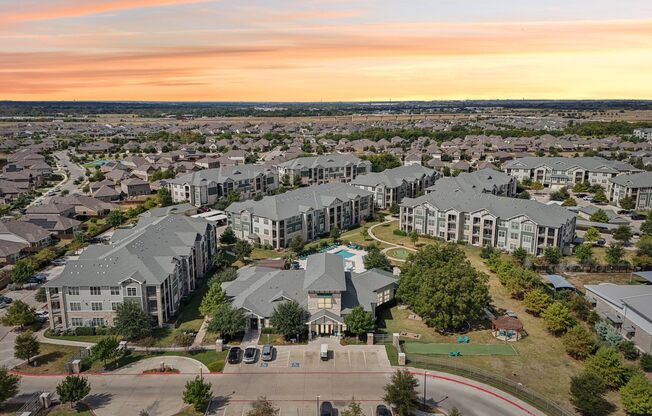 A large apartment complex with a playground in the foreground.