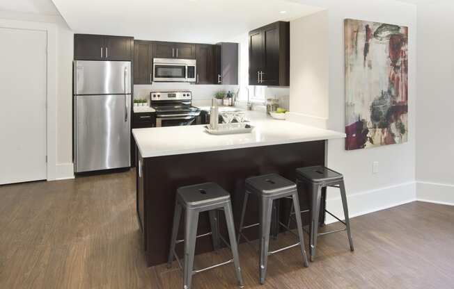 kitchen with a center island with three stools