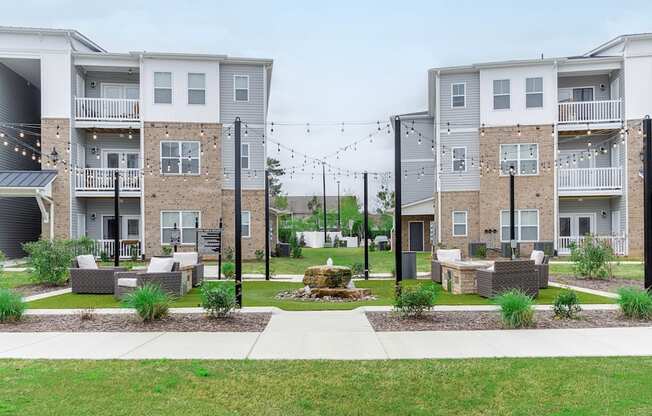 a courtyard with a fountain in the middle of an apartment complex