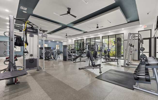 Gym with weights and cardio equipment with glass doors at Pearce at Pavilion Luxury Apartments, Riverview, FL
