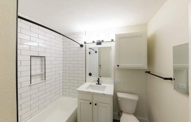 A white bathroom with a white toilet and sink.