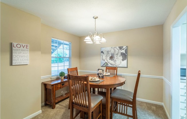 a dining room with a table and chairs