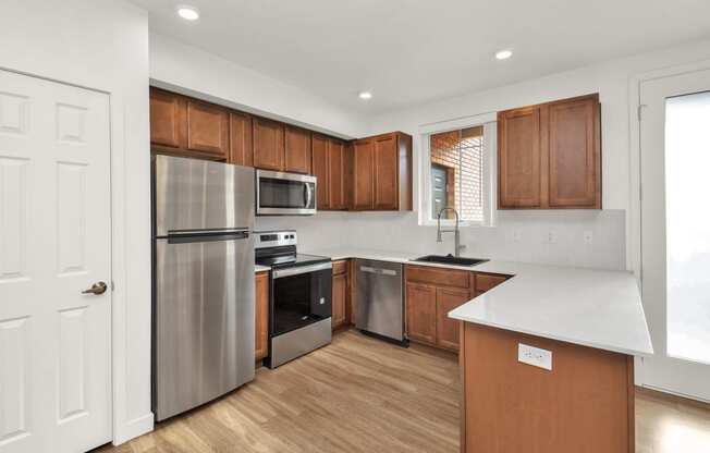 a kitchen with stainless steel appliances and wooden cabinets