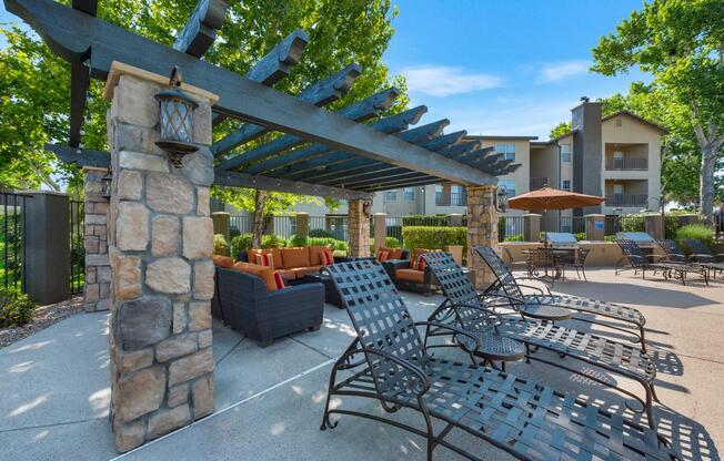 Pool Recliner Chairs Under Pergola at River Walk Apartments