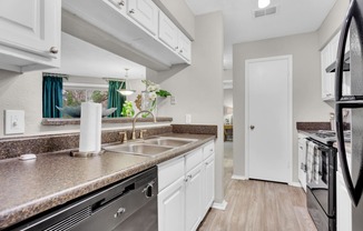 a kitchen with granite counter tops and a stainless steel sink at Madison Brookhaven, Atlanta