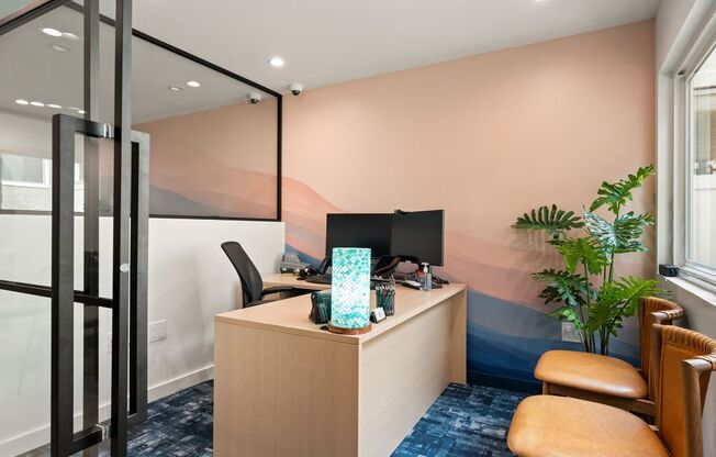 A room with a desk, chair, and a computer monitor.